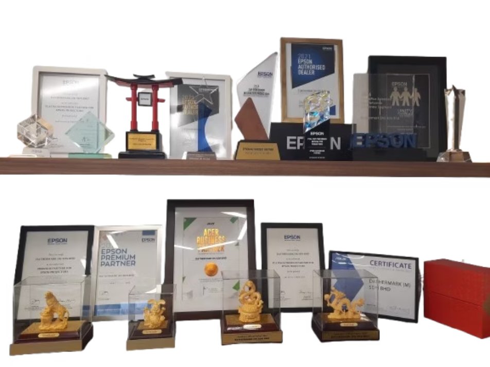 Dathermark's award shelf: Epson partner plaques and trophies, a ViewSonic partner certificate and an Acer Business Partner award
