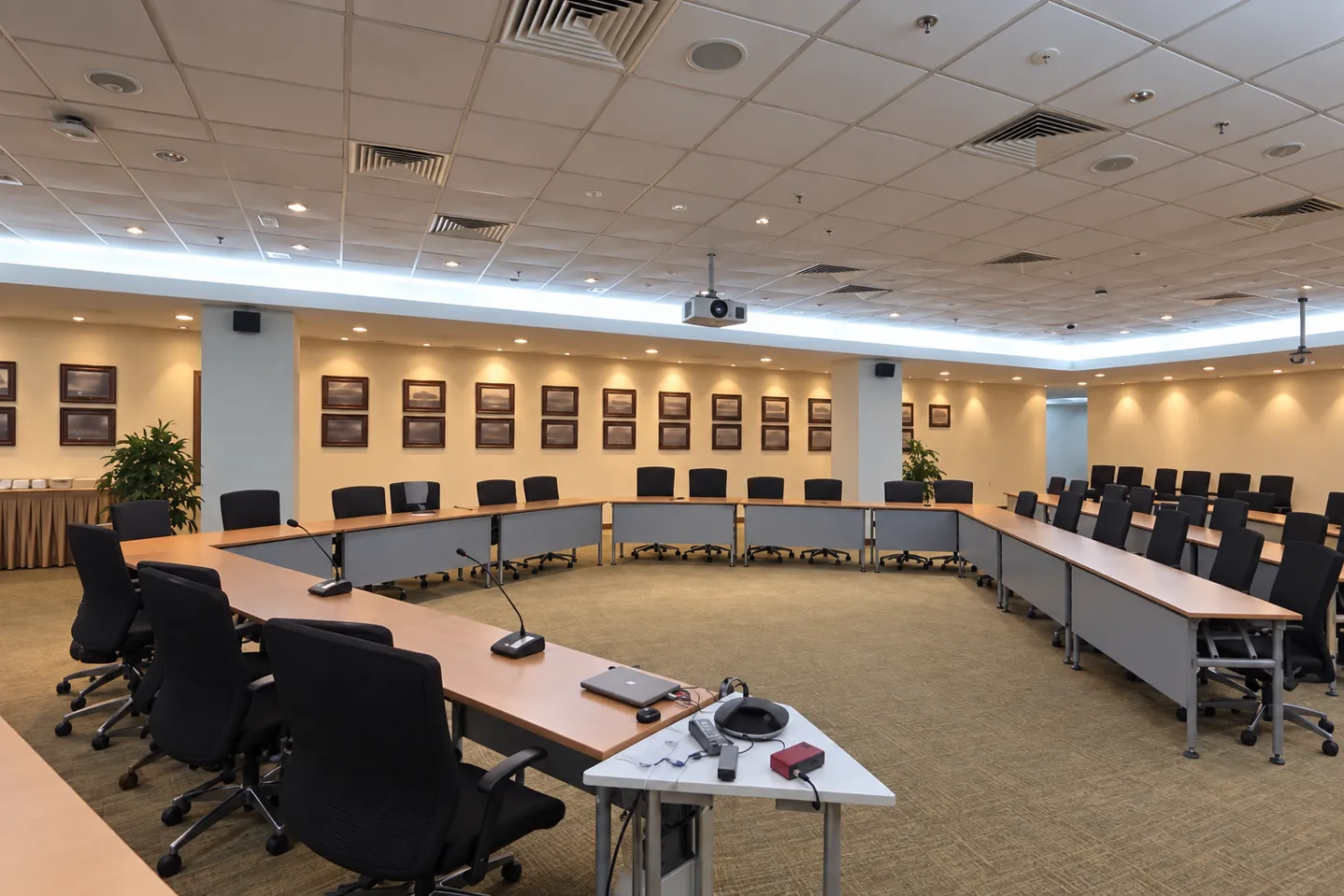 Conference room with a U-shaped table and AV system