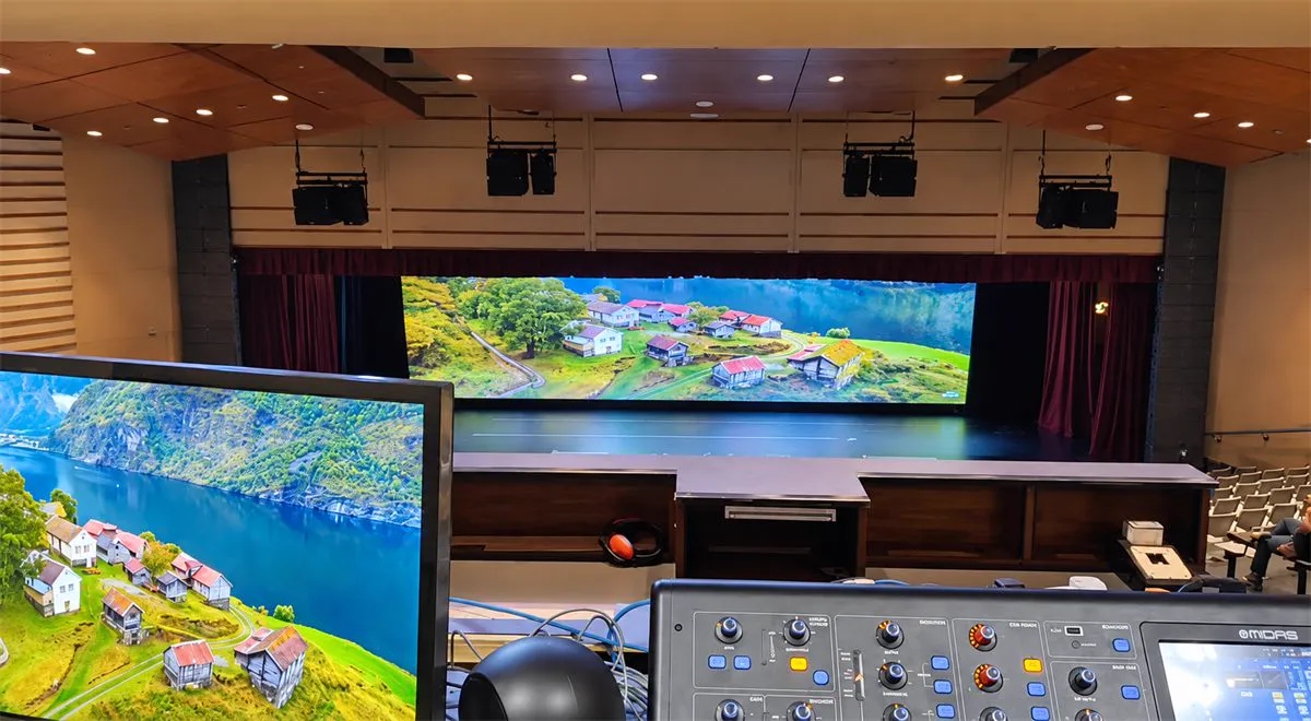 Nexus International School theatre, edge-blended projection across the stage seen from the control desk
