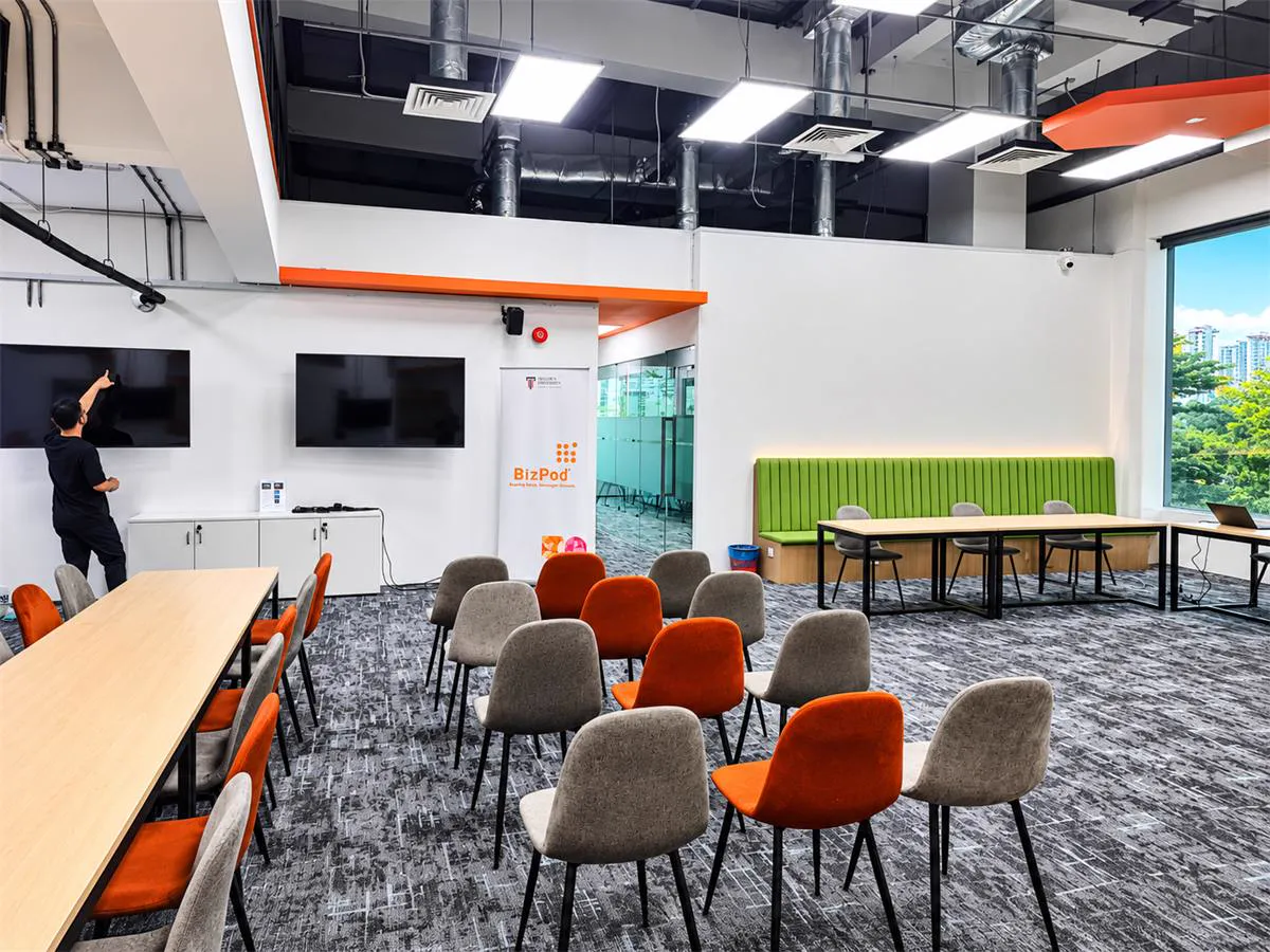 BizPod workspace with wall-mounted display TVs and ceiling speakers