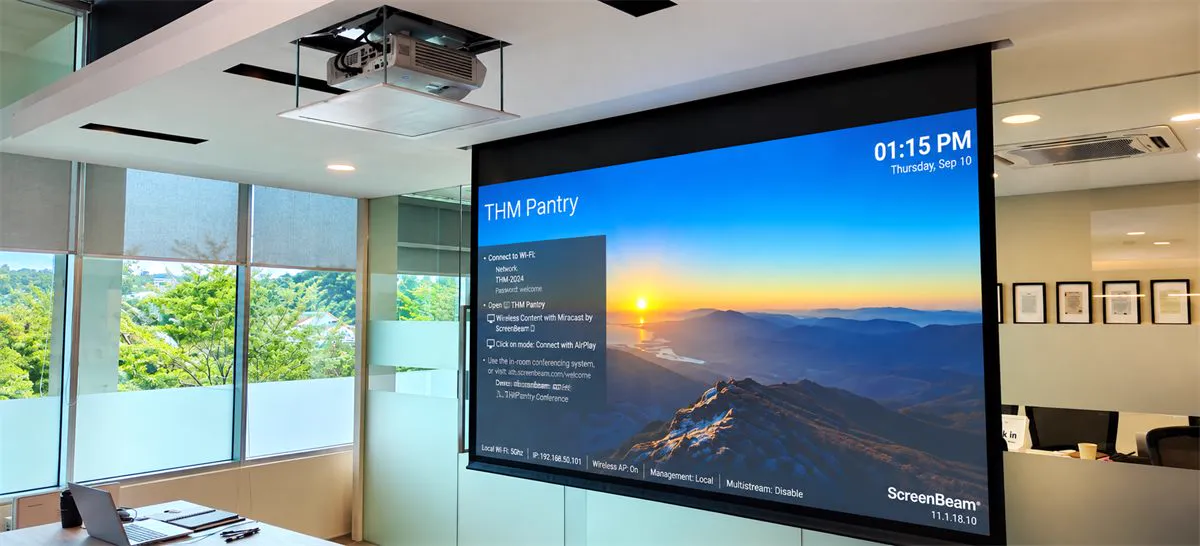 Pantry meeting space with a ScreenBeam wireless presentation screen and ceiling projector